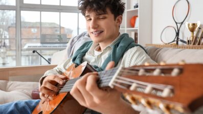 Young person playing guitar